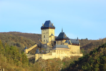 Fototapeta na wymiar Karlstejn is a medieval castle on the slopes of a high cliff