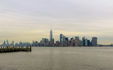 Obraz na płótnie Canvas Manhatten, New York City skyline with Hudson river and grey skies