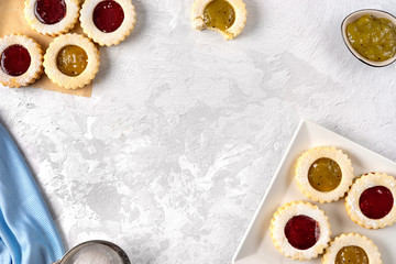 Top view of colorful linzer cookies on light background