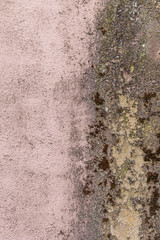 Water damage on a pink concrete wall makes an interesting textured background