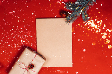 old parchment with christmas decorations on red background.