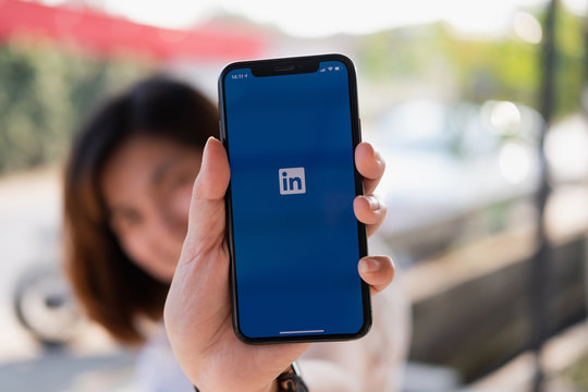 CHIANG MAI, THAILAND, DEC 12, 2019 : A women holds Apple iPhone Xs with LinkedIn application on the screen.LinkedIn is a photo-sharing app for smartphones.