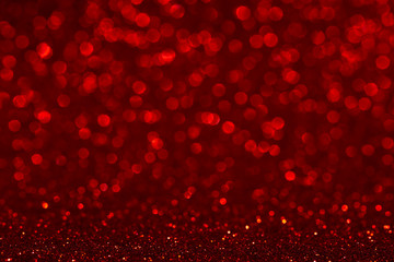 Christmas abstract texture, red sparkles bokeh shining background.