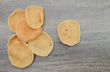 Pile of crunchy prawn crackers wooden board.