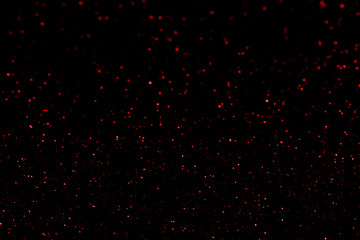 Red glitter bokeh lights on black background, unfocused. Holiday time. overlay layer