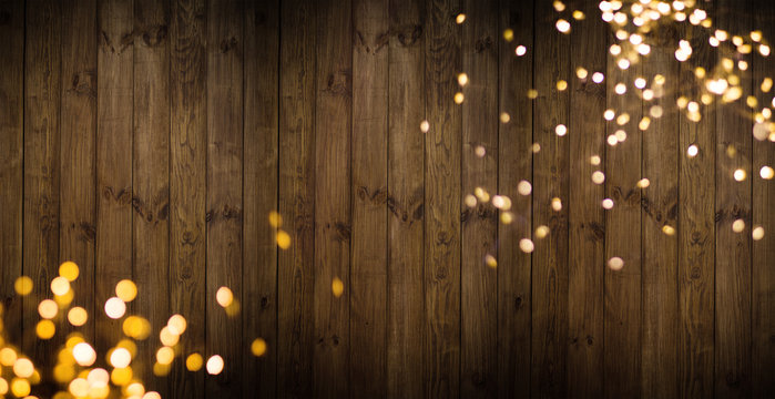 Golden lights on wooden background