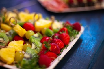 party platter with fruit strawberries, pineapple, kiwis