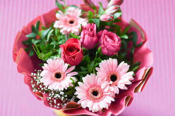 Pink bouquet of flowers on pink background