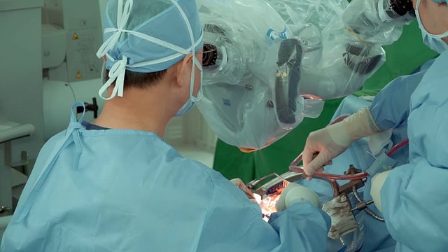 Surgeon performs surgery on human skull through electron microscope