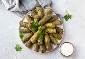 Dolma served with homemade yoghur. Azerbaijani and Turkish cuisine, grape leaves stuffed with minced meat and rice. Top view