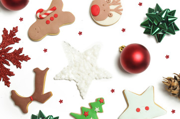 Festive winter background. Red Christmas ornaments and gingerbead cookies isolated on white background. Christmas, winter holiday, new year concept.
