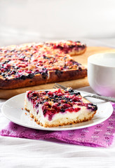 Tasty breakfast. Delicious pie with berries and cottage cheese an a cup of tea