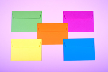 tidy coloured envelopes on a light pink background