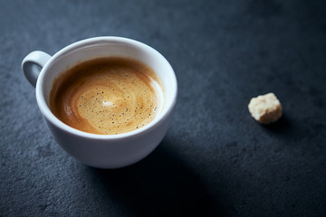 Cup of coffee on dark stone background. Close up. 