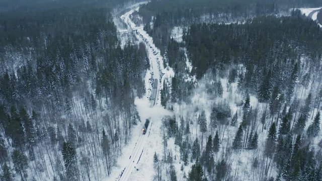 Steam train in winter snowy forest