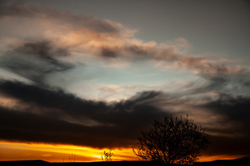Fototapeta na wymiar Sunset sky. Dramatic cloudy golden blue sunrise
