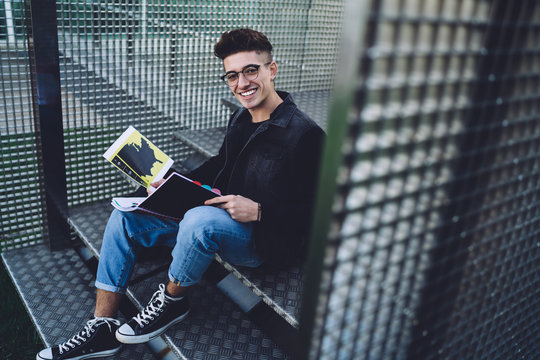 Student with diagrams and schemes in notebook looking at camera