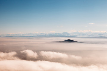 aerial view on a mountains covered clouds from the plane