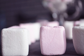 Hot winter drink with candies, Christmas or New Year decorations, dark background, rustic style, colored marshmallows.