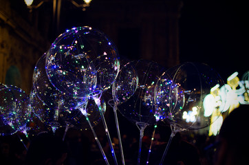 Selective focus on LED balloons with Christmas decorations in the background in Plaza San Francisco, Seville, Spain