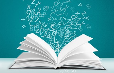 Open book with letters flying away. Education concept