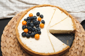 homemade cheesecake with blueberries and physalis. Classic cheesecake. Beautiful cake