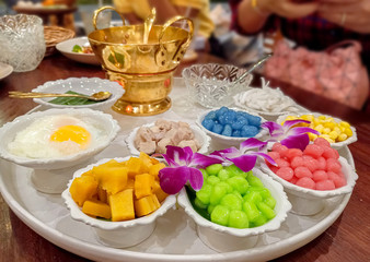 Fototapeta na wymiar Thai Dessert name Bualoy or ( Bua Loy ) Rice balls colourful in sweet creamy coconut milk syrup and eggs . Bua loy is the best dessert menu recommended in Thailand.