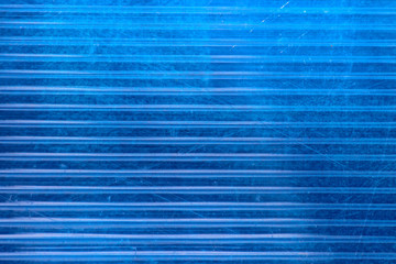 Texture of an old scratched blue polycarbonate honeycomb panel