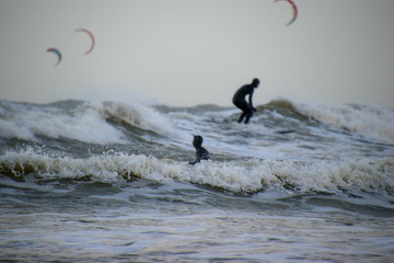 Two men surfing in the wild waves of the North Sea.