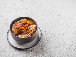 Oatmeal with fried banana. White background table