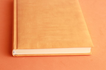 book with orange cover on colorful background