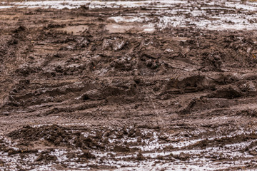 dirty mud road background at winter with selective focus and blur  - obrazy, fototapety, plakaty