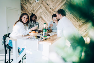 Laughing group of friends talking on table