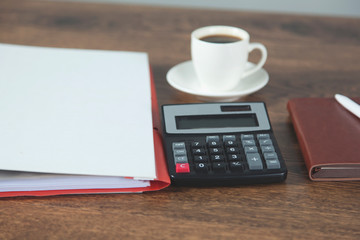 calculator with cupof coffee on desk