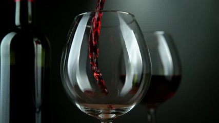 Super slow motion of pouring red wine into glass with rotate motion. Filmed on high speed cinema camera, 1000 fps - Powered by Adobe