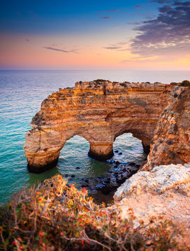 Heart-shaped cliffs on the shore of Atlantic ocean in Algarve, Portugal. Beautiful summer landscape. © smallredgirl