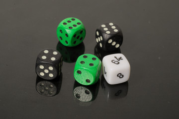 dice on a black background with reflection