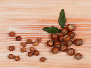 Raw hazelnuts on light wooden background