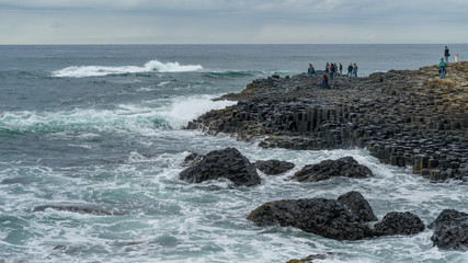 Tourists on the coast, Giant's Causeway, County Antrim, Northern Ireland, Ireland