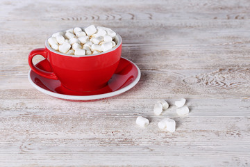 A large red cup with coffee and marshmallows. View from above. Copy space. Still life concept.