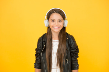 happy smile. hipster urban style girl. lifestyle concept. biker kid in headset. small girl in leather jacket. autumn fashion style. child listen rock music. little school radio dj. lady DJ long hair