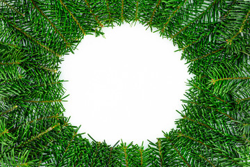 Fototapeta na wymiar A frame made of fir branches, a blank space in the form of a circle in the middle, isolated on a white background.