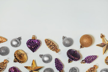 Vintage Christmas tree baubles decorative background. Silver, purple, and golden old fashioned ornaments. Glass pine cones, stars balls. Horizontal New Year bright backdrop with copyspace.