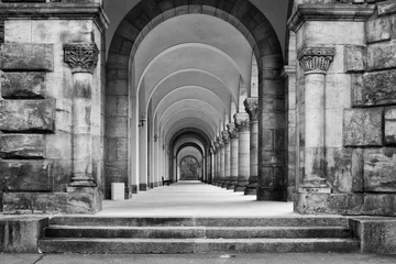 Wall murals Old building Greyscale shot of a concrete ancient building with a long hallway