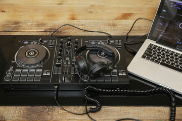  DJ equipment controller and headphones and laptop. Music background, banner, card. Modern...