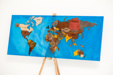 Wooden world map covered with epoxy resin.