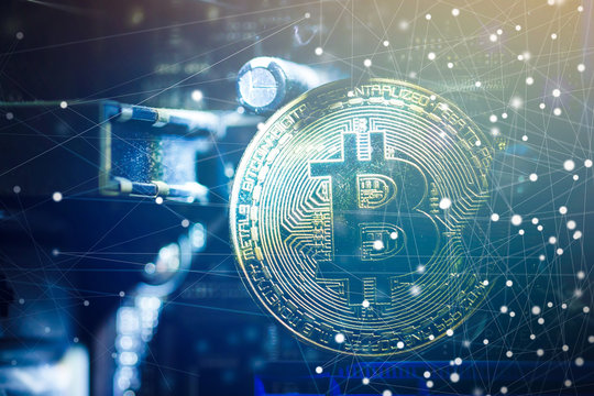 Golden bitcoin cryptocurrency on computer circuit board
