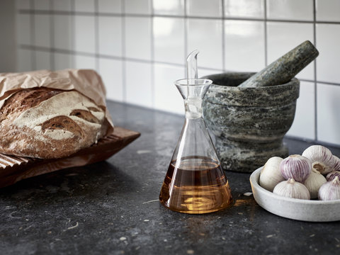 Oil, garlic and bread on worktop