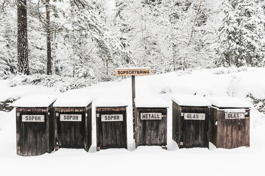 Wooden recycling bins at winter