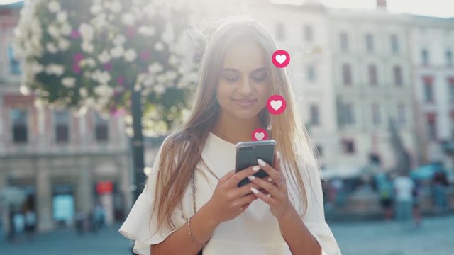 Beautiful happy girl young blogger checking smartphone receivig a pile of Instagram likes rising popularity. Like counter animation of pink hearts love icons flow. 3D rendering.